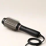 Illustration of a black corded hot-air brush with an oval barrel