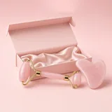 Illustration of a pink rose quartz roller and gua sha in a blush gift box